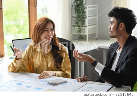 Start up businesspeople collaborating on their new project together at bright modern office Start up businesspeople collaborating on their new project together at bright modern office 92515643