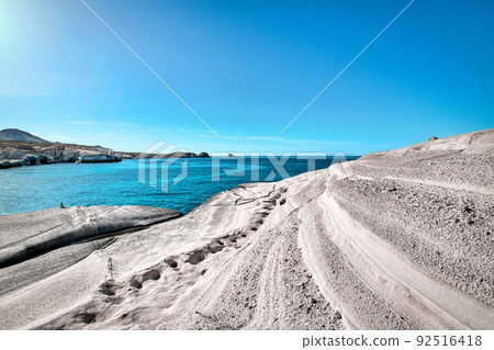 Beautiful landscape of white rocks on Sarakiniko beach, Aegean sea, Milos island, Greece. Empty cliffs, summer sunshine, clear sea water, azure lagoon 92516418