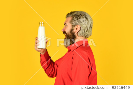 Homemade yoghurt. Simple tutorial for how to make yogurt. Bearded man hold milk bottle. Probiotic characteristics. Creamy and absolutely delicious yogurt. Breakfast concept. Thirsty hipster drinking 92516449