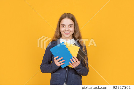 happy girl with microscope point finger on yellow background with copy space. 92517501
