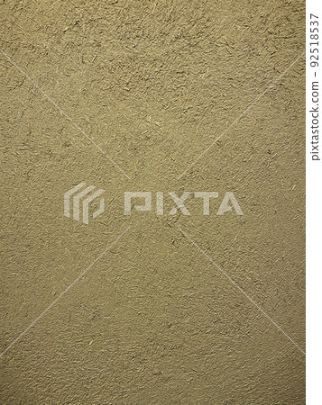 Vertical background image of the surface where the rough texture of straw remains in the sand-colored clay wall Vertical background image of the surface where the rough texture of straw remains in the sand-colored clay wall 92518537