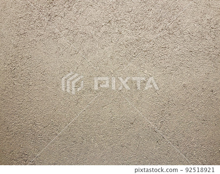 Horizontal background image of the surface where the rough texture of straw remains in the light brown soil wall Horizontal background image of the surface where the rough texture of straw remains in the light brown soil wall 92518921