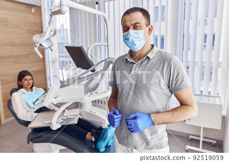 Portrait of confident male dentist in modern stamotology cabinet 92519059