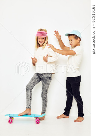 Portrait of two young smiling kids casual street style isolated background Portrait of two young smiling kids casual street style isolated background 92519165
