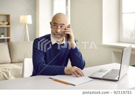 Senior businessman have smartphone call with client 92519781