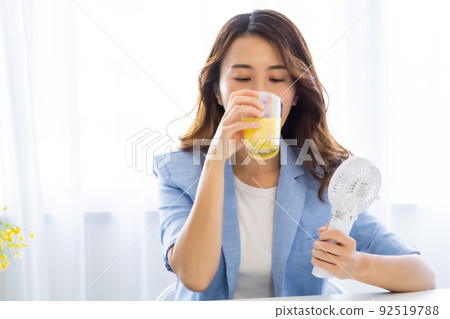一個用風扇冷卻的女人 92519788