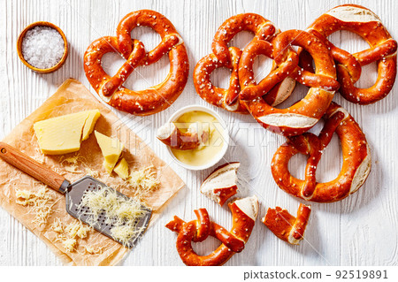 pretzels in the form of knot with cheese sauce 92519891