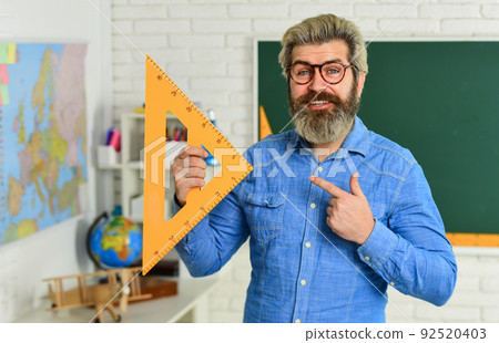 geometric shapes. physics research. math teacher at blackboard. education. exact sciences. happy bearded teacher in glasses. back to school. develop logic and creativity. start the brain engine geometric shapes. physics research. math teacher at blackboard. education. exact sciences. happy bearded teacher in glasses. back to school. develop logic and creativity. start the brain engine 92520403