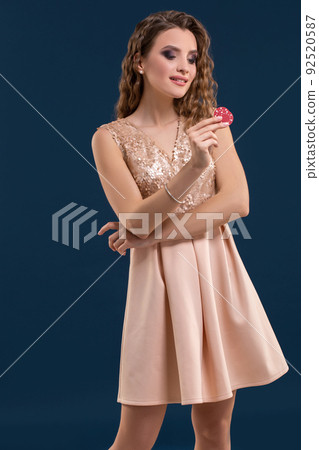 Beautiful young woman with casino chips on dark blue background 92520587