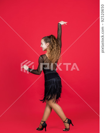 kid dancing in black dress. child in dance pose. professional slowfox and quickstep. waltz and tango. dancewear fashion clothes. dancing school. teen girl ballroom dancer kid dancing in black dress. child in dance pose. professional slowfox and quickstep. waltz and tango. dancewear fashion clothes. dancing school. teen girl ballroom dancer 92520650