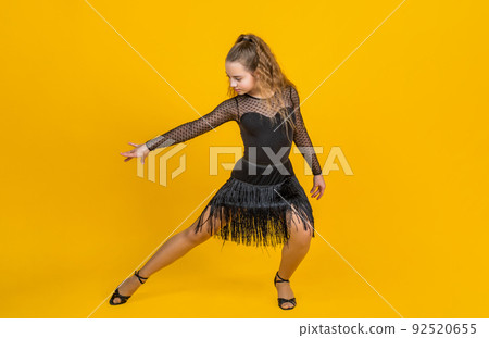 life in motion. child in dance pose. professional slowfox and quickstep. waltz and tango. dancewear fashion clothes. dancing school. teen girl ballroom dancer. kid dancing in black dress life in motion. child in dance pose. professional slowfox and quickstep. waltz and tango. dancewear fashion clothes. dancing school. teen girl ballroom dancer. kid dancing in black dress 92520655