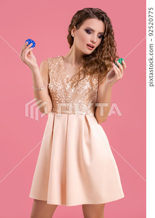 Pretty long hair woman holding chips for gambling. Studio shot Pretty long hair woman holding chips for gambling. Studio shot 92520775