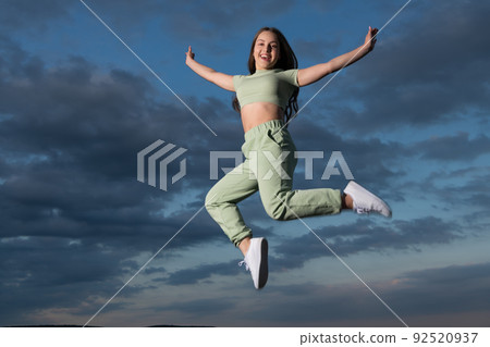 happy teen girl jump high on sky background happy teen girl jump high on sky background 92520937