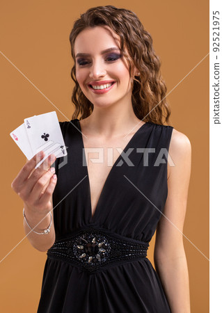 Beautiful caucasian woman with poker cards gambling in casino. Studio shot 92521975