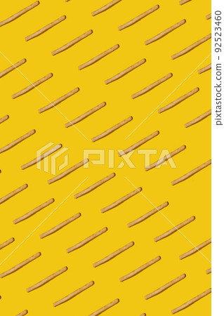 Heap of french fries on yellow background, top view Heap of french fries on yellow background, top view 92523460