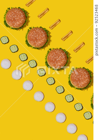 Design concept of mockup burgers and french fries set on yellow background. 92523468