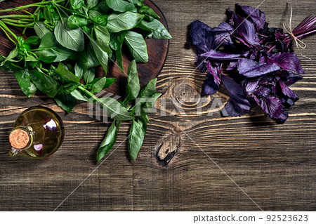 Green and purple fresh basil on wooden background. Top view Green and purple fresh basil on wooden background. Top view 92523623