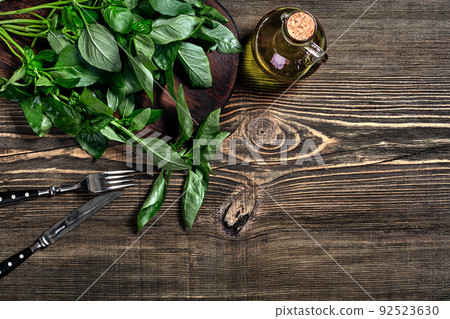 Green and purple fresh basil on wooden background. Top view 92523630