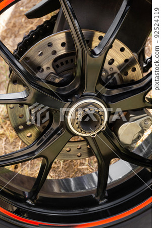 Black motorcycle wheel with contrasting orange stripe Black motorcycle wheel with contrasting orange stripe 92524119