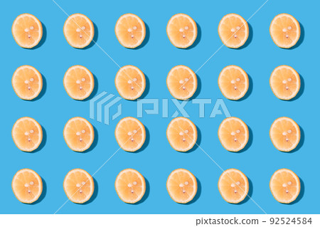 Summer pattern of yellow lemon slices on light-mint background. 92524584