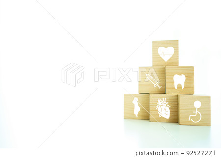 Health care and wellbeing concept in icon on wooden block with copyspace. Health care and wellbeing concept in icon on wooden block with copyspace. 92527271