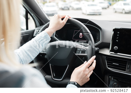 Business woman driving a modern car. Business woman driving a modern car. 92528417