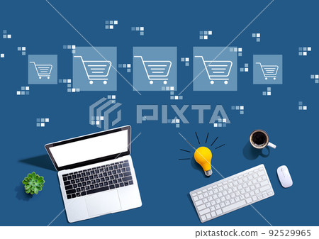 Online shopping theme with computers with a light bulb Online shopping theme with computers with a light bulb 92529965