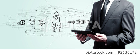 Rapid growth concept with businessman holding a tablet Rapid growth concept with businessman holding a tablet 92530175