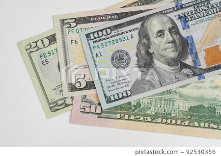 5, 20, 50, 100 dollars banknotes at different angles. Close up of dollars on white background. 92530356
