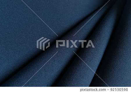 Blue crumpled or wavy fabric texture background. Abstract linen cloth soft waves. Gabardine wool fabric. Merino yarn. Smooth elegant luxury cloth texture. Concept for banner or advertisement. Blue crumpled or wavy fabric texture background. Abstract linen cloth soft waves. Gabardine wool fabric. Merino yarn. Smooth elegant luxury cloth texture. Concept for banner or advertisement. 92530598