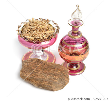 Essential oil of Agarwood, aloeswood, eaglewood or gharuwood. Piece of wood and shavings. Isolated Essential oil of Agarwood, aloeswood, eaglewood or gharuwood. Piece of wood and shavings. Isolated 92531003