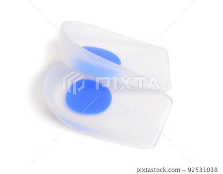 A pair of orthopedic silicone insoles isolated on white. A pair of orthopedic silicone insoles isolated on white. 92531018