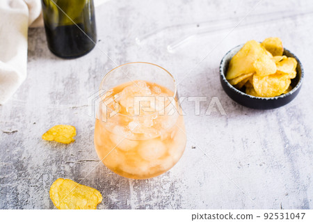 Beer slush in a glass and chips in a bowl on the table. Trendy summer drink 92531047