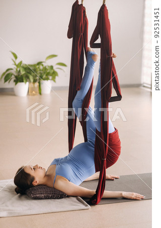 Pregnant girl. A woman does yoga on a hammock in the gym. The concept of a healthy lifestyle, Motherhood Pregnant girl. A woman does yoga on a hammock in the gym. The concept of a healthy lifestyle, Motherhood 92531451