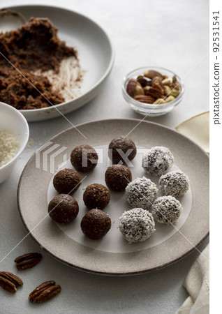 Energy balls. Cooking healthy raw dessert vegetarian candies made of dates, hazelnuts, cocoa powder Energy balls. Cooking healthy raw dessert vegetarian candies made of dates, hazelnuts, cocoa powder 92531541