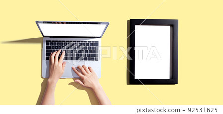 Laptop computer with a blank photo frame Laptop computer with a blank photo frame 92531625