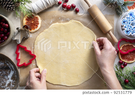 Cooking Christmas cookies. Female hands working with raw dough. Step by step recipe. 92531779