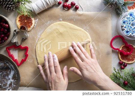 Cooking Christmas cookies. Hands and rolling pin. Step by step recipe. 92531780