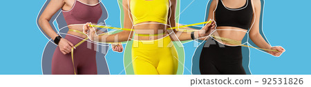 Cropped young ladies athlete in sportswear with overweight women drawn around measures waist with measuring tape Cropped young ladies athlete in sportswear with overweight women drawn around measures waist with measuring tape 92531826