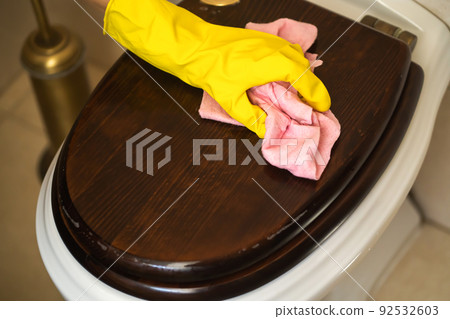 Girl is cleaning house with a detergent. 92532603