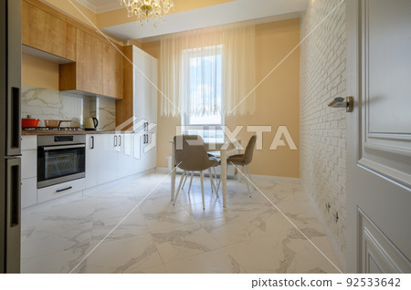 White and wooden modern kitchen and dining room interior White and wooden modern kitchen and dining room interior 92533642