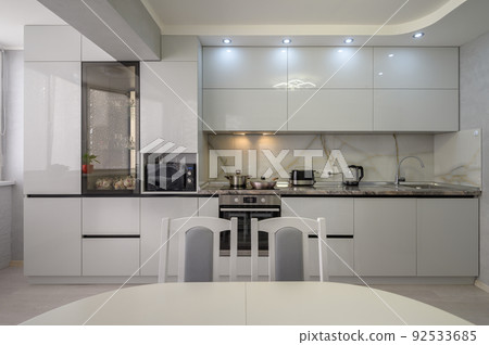 Interior of modern trendy white kitchen, front view 92533685