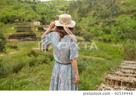 Young lady standing and looking at coffee farm in South Africa Young lady standing and looking at coffee farm in South Africa 92534448