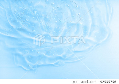 Hyaluronic acid fluid skincare product with bubbles. Blue jelly sanitiser abstract pattern, cleansing emulsion macro. Hyaluronic acid fluid skincare product with bubbles. Blue jelly sanitiser abstract pattern, cleansing emulsion macro. 92535756