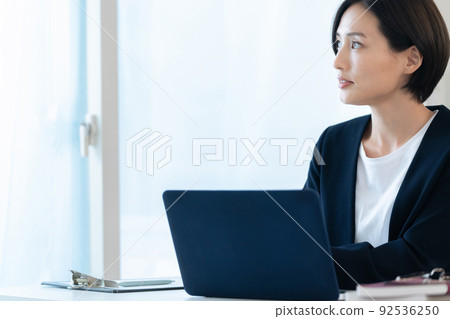 Career women heading to a computer Career women heading to a computer 92536250