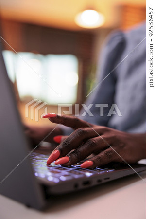 Young african american female freelancer typing on laptop keyboard, close view on hands. Businesswoman browsing internet, writing email on computer, focus on manicured nails Young african american female freelancer typing on laptop keyboard, close view on hands. Businesswoman browsing internet, writing email on computer, focus on manicured nails 92536457