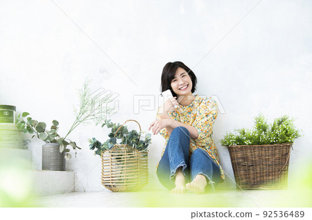 Smartphone female portrait cute looking at the camera Smartphone female portrait cute looking at the camera 92536489