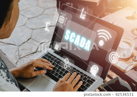SCADA Supervisory control and data acquisition technology concept, Woman hand typing on keyboard computer with SCADA icon on virtual screen. SCADA Supervisory control and data acquisition technology concept, Woman hand typing on keyboard computer with SCADA icon on virtual screen. 92536531