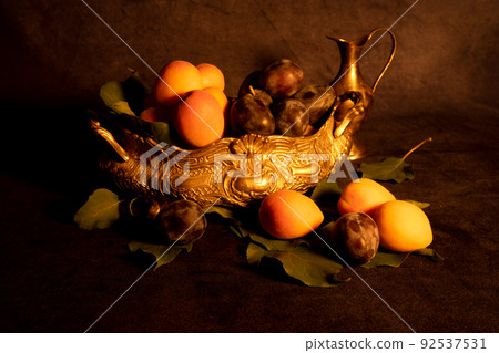 Image Decoration from fresh apricots and plums. Still life, Nature Morte in dramatically dark setting and background. 92537531