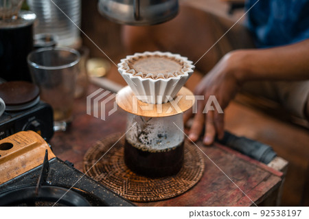 Drip coffee, barista pouring water on coffee ground with filter 92538197